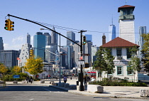 USA, New York, Brooklyn Bridge Park, Fulton Ferry Pier with The Brooklyn Ice Cream Factory beside Old Fulton Street with the skyscraper skyline of Lower Manhattan beyond.