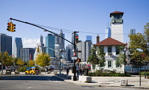 USA, New York, Brooklyn Bridge Park, Fulton Ferry Pier with The Brooklyn Ice Cream Factory beside Old Fulton Street with the skyscraper skyline of Lower Manhattan beyond.