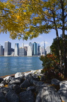 USA, New York, Lower Manhattan skyline skyscrapers and East River seen in autumn from Brooklyn Bridge Park.
