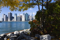 USA, New York, Lower Manhattan skyline skyscrapers and East River seen in autumn from Brooklyn Bridge Park.