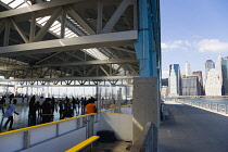 USA, New York, Brooklyn Bridge Park rollerskating rink on Pier 2 with Lower Manhattan skyscraper skyline beyond.