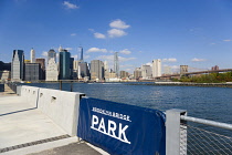 USA, New York, Lower Manhattan skyline skyscrapers and East River seen from Pier 2 in Brooklyn Bridge Park.