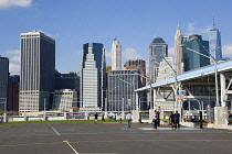 USA, New York, Brooklyn Bridge Park basketball courts on Pier 2 with Lower Manhattan skyscraper skyline beyond.