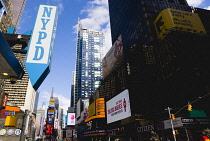 USA, New York, Manhattan, Times Square in the Theater District with skyscrapers carrying advertising and a large NYPD sign.