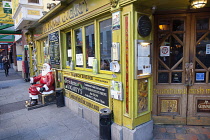 Ireland, Dublin, Temple Bar, Exterior of the Oliver St John Gogarty traditional Irish pub in Fleet Street with a Santa Claus Statue on the pavement.