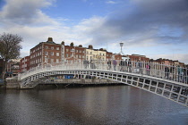 Ireland, Dublin, People crossing the Ha'penny Bridge across River Liffey viewed from the Temple Bar side.