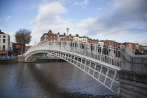 Ireland, Dublin, People crossing the Ha'penny Bridge across River Liffey viewed from the Temple Bar side.