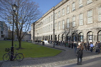 Ireland, Dublin, Trinity College buildings on College Green, Tourists queuing to enter the library to see the Book of Kells.