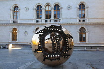 Ireland, Dublin, Trinity College, Arnaldo Pomodoro's Sphere within a Sphere sculpture outside the Berkeley Library.