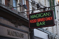 Ireland, Dublin, Neon sign outside Madigans bar in Earl Street.
