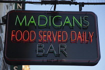 Ireland, Dublin, Neon sign outside Madigans bar in Earl Street.