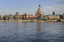 Germany, Saxony, Dresden, The city skyline with cruise boats moored on the flooded River Elbe in front of the embankment buildings on the Bruhl Terrace including the Albertinum and the dome of the Fra...
