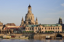 Germany, Saxony, Dresden, Section of the city skyline with cruise boats moored on the flooded River Elbe in front of the embankment buildings on the Bruhl Terrace including the dome of the Frauenkirch...