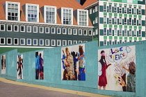 Netherlands, Noord Holland, Zaandam, Zaandam Town Hall, A section of the building with pedestrian walkway and murals in the foreground.