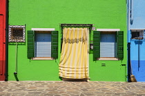 Italy, Veneto, Burano Island, Colourful row of house facades.