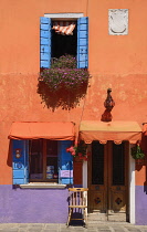 Italy, Veneto, Burano Island, Colourful row of house facades.