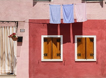 Italy, Veneto, Burano Island, Colourful row of house facades.