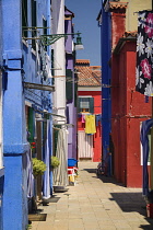 Italy, Veneto, Burano Island, A colourful alleyway.