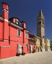 Italy, Veneto, Burano Island, Leaning tower of Chiesa di San Martino fronted by colourful houses.