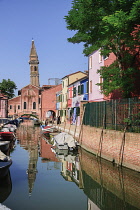 Italy, Veneto, Burano Island, Chiesa di San Martino reflected in small canal.