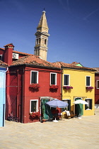 Italy, Veneto, Burano Island, The Leaning tower of Chiesa di San Martino fronted by colourful houses.