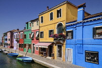 Italy, Veneto, Burano Island, Colourful housing and boats on Fondamenta di Cavanella.