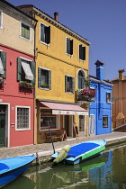 Italy, Veneto, Burano Island, Colourful housing and boats on Fondamenta di Cavanella.