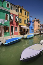 Italy, Veneto, Burano Island, Colourful housing and boats on Fondamenta di Cavanella.