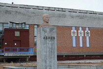 Norway, Svalbard, Pyramiden, Russian settlement, Most northerly statue of Lenin in the World, Miners social and welfare building in the background, now abandoned, contains a cinema and the most northe...