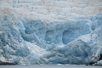 Norway, Svalbard, Nordenskild Glacier, Blue ice, Ice worn rock outcrop, Glacier front ready to calve ice into the fjord.