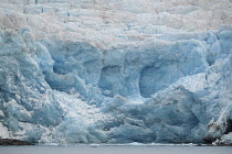 Norway, Svalbard, Nordenskild Glacier, Blue ice, Ice worn rock outcrop, Glacier front ready to calve ice into the fjord.