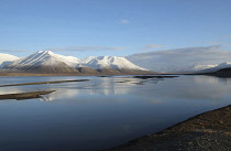 Norway, Svalbard, Longyearbyen, View across Adventfjorden toward snow capped mountain.