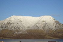 Norway, Svalbard, Longyearbyen, View across Adventfjorden toward snow capped mountain.