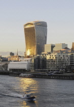 England, London, The Modern skyline of the City with The Walkie Talkie building with sunlight reflected in the River Thames.