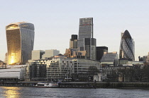 England, London, The Modern skyline of the City with The Walkie Talkie Building, The Gherkin, The Cheesegrater at sundown and the River Thames.