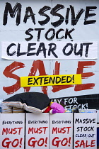 Business, Shops, Shopping, Massive Stock Clear Out Sale Extended sign in the window of a high street shop.