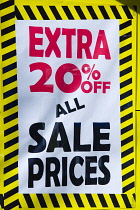 Business, Shops, Shopping, Extra 20% Off Sale Prices sign in the window of a high street shop.