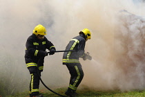 Essential Services, Firemen putting out fire in a wooden out building