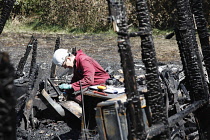 Essential Services, Fire, Forensic team examing charred ruin for potential causes of fire.