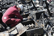 Essential Services, Fire, Forensic team examing charred ruin for potential causes of fire.