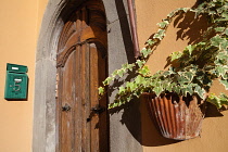 Italy, Tuscany, Lucca, Barga, Arched door and letter box to a house in the old town.