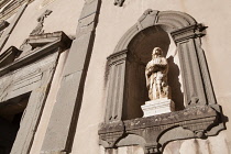 Italy, Tuscany, Lucca, Barga, Statue on the facade of Chiesa del St Crocifisso.