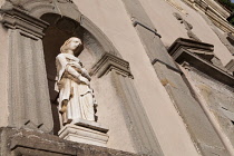 Italy, Tuscany, Lucca, Barga, Statue on the facade of Chiesa del St Crocifisso.