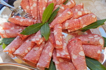 Italy, Tuscany, Lucca, Barga, Display of sliced meat as part of a buffet to be eaten with aperitifs.