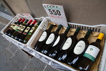 Italy, Tuscany, Lucca, Barga, Bottles of red & white wine for sale in the old town.