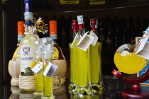 Italy, Tuscany, Lucca, Barga, Display of Limoncino in an Enoteca regional wine shop.