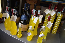 Italy, Tuscany, Lucca, Barga, Display of Limoncino & Ruffino Chiante in an Enoteca regional wine shop.