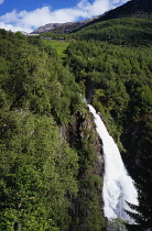 Norway, Sogn og Fjordane, Naeroydalen, Stalheimfossen waterfall cascading into steep  wooded valley.