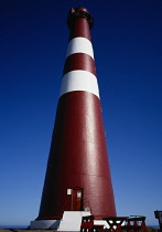 Norway, Finnmark, Nordkinnhalvoya, Slettnes TWR lighthouse.  Red and white exterior with sign stating that it is the most northerly lighthouse situated on the mainland in the world.  39 metres high.