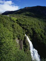 Norway, Hordaland, Naeroydalen, Stalheimfossen.  White waterfall crashing into steep sided valley gorge from area of dense forest.
